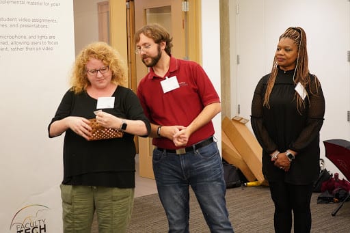 Members of the Faculty Technology Receptions planning committee (left to right: Astrid Fingerhut, Jason Edelstein, and Cheryl Walker) hold a drawing for door prizes.
