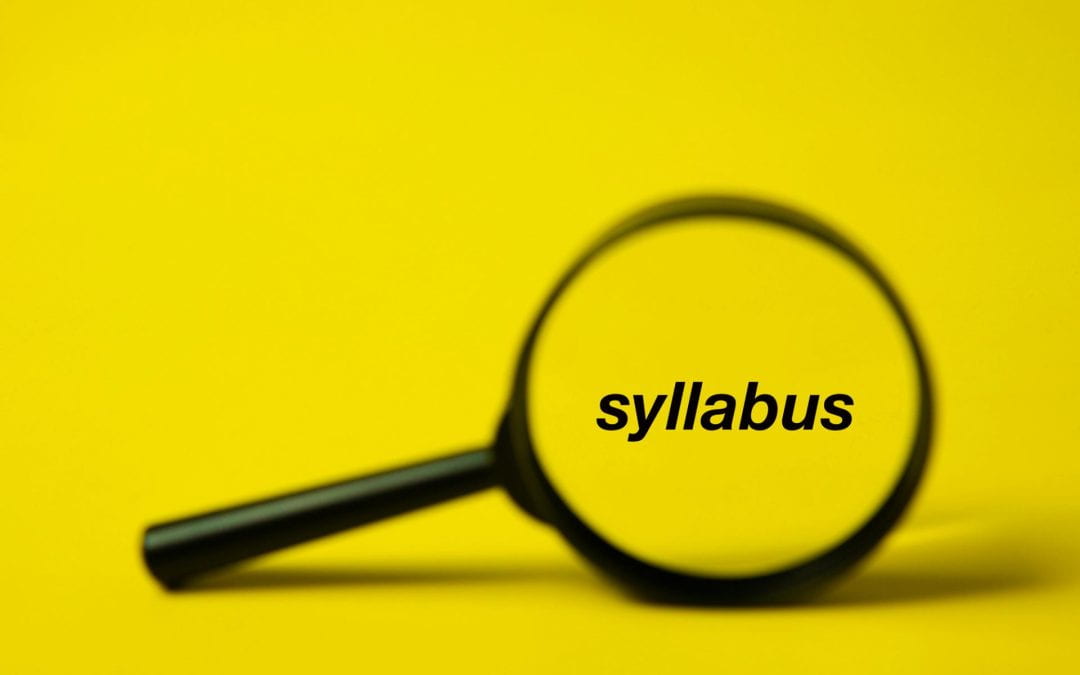 A magnifying glass with the word "syllabus" being magnified at the center of its lens